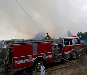 Santa Rosa firefighters work on a fire on the side of a road near the Oakmont area in Santa Rosa, Calif. (AP Photo/Jeff Chiu)