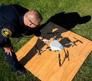 In an Aug. 14, 2015 file photo, Alameda County Sheriff's Deputy Dave Durbin prepares to fly a drone during a demonstration of a search and rescue operation, in Dublin, Calif.
