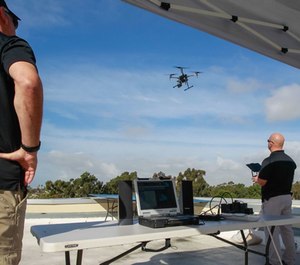 Police officer Laurence Meyerowitz (right) and retired captain Fritz Reber (left) watch a drone land that is being piloted from a remote room in the building during a practice and training program on Friday in Chula Vista, Calif. (Photo/TNS)