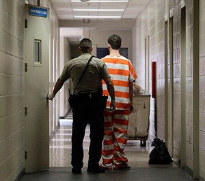 In this Feb. 21, 2013 file photo, an inmate at the Madera County Jail is taken to a housing unit at the facility in Madera, Calif. (AP Photo/Rich Pedroncelli)