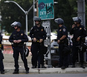 Officers monitor a freeway on-ramp on Saturday, Nov. 12, 2016, as thousands of anti-Donald Trump protestors march from MacArthur Park to the U.S. Federal Building in downtown Los Angeles.