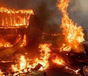 Police are investigating Camp fire cleanup workers who posted offensive photos of the aftermath of the deadly wildfire. (Photo/AP)