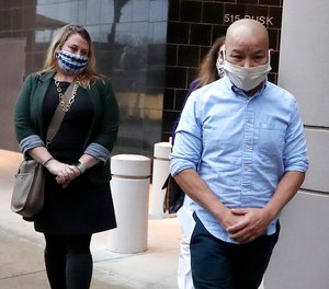 In this Jan. 21, 2021, photo former Houston Police Officer Tam Pham walks out of the Federal Courthouse downtown in Houston after he appeared in court following his arrest Wednesday on federal charges tied to Capitol violence. (Karen Warren/Houston Chronicle via AP)