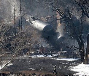 A crew member walks near the scene of a train derailment near Mount Carbon, W.Va.