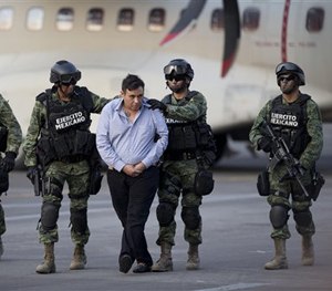 Soldiers escort a man who authorities identified as Omar Trevino Morales, alias 