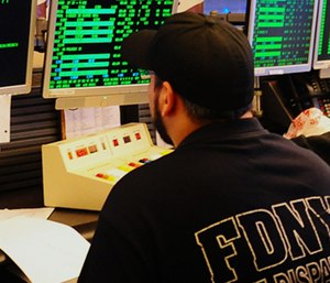 An FDNY dispatcher takes calls in the dispatch center.