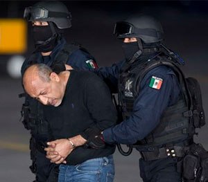 Federal police escort who they identify as Servando
