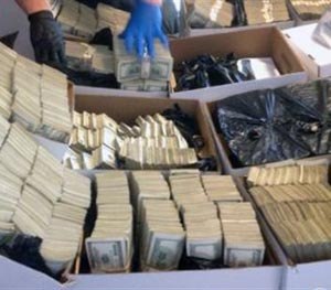This photo provided by U.S. Immigration and Customs Enforcement shows boxes of cash that was part of seizure by Homeland Security Investigations in Los Angeles on Wednesday, Sept. 10, 2014. Federal authorities have arrested nine people and seized roughly $65 million in a crackdown on suspected drug money laundering in the fashion district of Los Angeles.