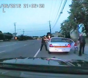 In this image made from July 6, 2016, video captured by a camera in the squad car of St. Anthony Police officer Jeronimo Yanez, the Minnesota police officer is shown after shooting into the vehicle at Philando Castile during a traffic stop in Falcon Heights, Minn.