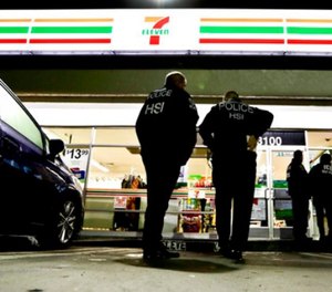 U.S. Immigration and Customs Enforcement agents serve an employment audit notice at a 7-Eleven convenience store Wednesday, Jan. 10, 2018, in Los Angeles. (AP Photo/Chris Carlson)