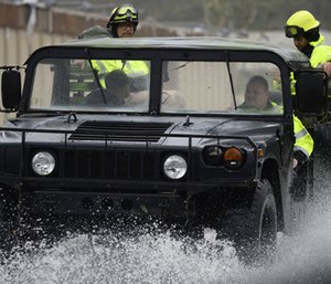 Rescue personnel from the Emergency Management Agency drive through a flooded road after Hurricane Maria hit the eastern region of the island.