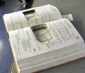 A hymnal with the pages cut to hide a cell phone in Bordentown, N.J. (AP Image)