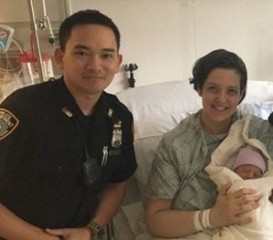 Officer Yan Kit Poon is pictured alongside the woman whose baby he and his EMT brother helped deliver.