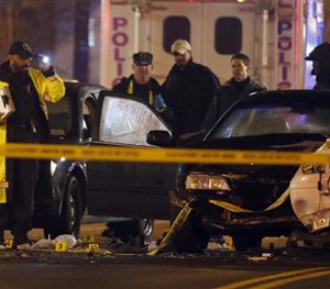 Law enforcement officers investigate the scene involving at least one wrecked DC Metro police car Thursday. (AP Image)