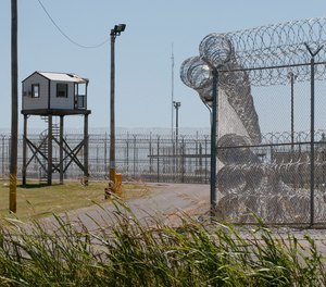 A tower is pictured outside of the razor wire at the Great Plains Correctional Facility in Hinton, Okla.