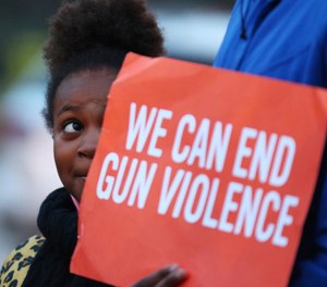 aniyah Scott, 8, stands next to her sister, Amari, 12, during a rally to bring attention to gun violence at 51st Street and King Drive on Nov. 24, 2018.