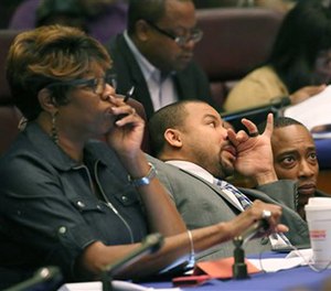 Aldermen Pat Dowell, third from left, Michael Scott Jr., and Gregory Mitchell, listen to testimony during committee hearings Tuesday, Oct. 4, 2016, at City Hall in Chicago.