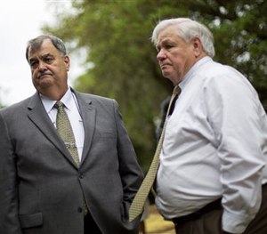 North Charleston Police Chief Eddie Driggers, left, and Mayor Keith Summey wait for a vigil to begin at a makeshift memorial, Sunday, April 12, 2015.