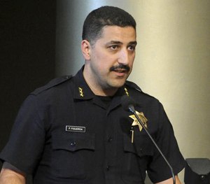 This July 16, 2013 photo shows Oakland Police Assistant Chief Paul Figueroa during a city council meeting in Oakland, Calif.