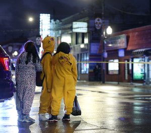 A group of children view a crime scene where a seven-year-old girl was shot while trick-or-treating.