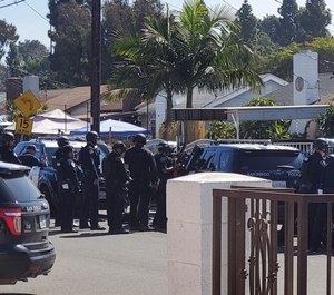 Police gather in Southcrest, Calif. where a 10-year-old child holed up in a shed and fired off two rounds from a shotgun Thursday morning, San Diego police said. (Photo/TNS)