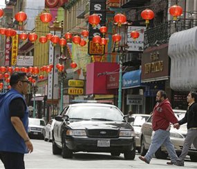 San Francisco police patrol the Chinatown district Thursday, March 27, 2014, in San Francisco.