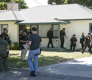 Officers are on scene at the home of attorney Frank Carson in Turlock, Calif., Friday, Aug. 14, 2015.