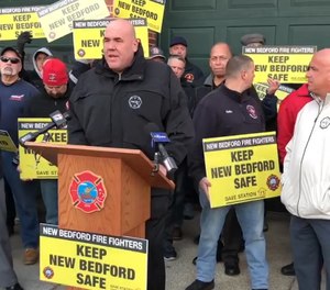 This video screenshot shows a press conference held in February outside Station 11 in New Bedford where union representatives and protesters called for city leaders to not close the station. New Bedford's fire chief announced in February that the station would need to close in order to end controversial blackout policies throughout the city. (Photo/New Bedford Firefighters IAFF Local 841 Facebook)