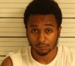 Christopher D.  Caldwell is being held on a $10,000 bond on charges of reckless driving and making threats of mass violence on school property.