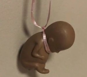 A Milwaukee firefighter has been suspended for 20 days after hanging a brown fetus-shaped figurine in a fire station kitchen in February.