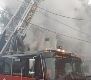 A Utica firefighter fell from the second floor to the basement of a burning home Sunday when a stairway in the home collapsed. (Photo/Utica Fire Department Facebook)