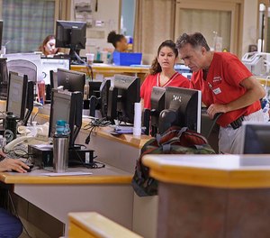 The emergency department at Tufts Medical Center in Boston is centered around a hub, where the staff works to manage the flow of patients. (Rick Wood/Milwaukee Journal Sentinel)