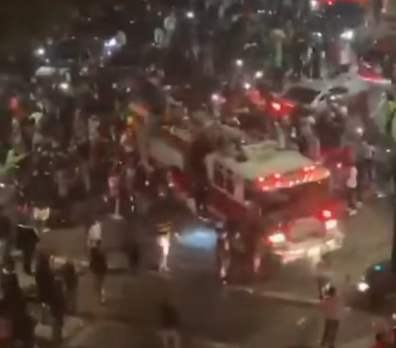 Video: Large crowd surrounds, climbs on responding Calif. fire engine