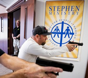 Jason Johnston, right, and Les Davis practice searching and clearing a hallway during a Sheepdog Defense Group armed security training program at Cornerstone Community Church in Springtown, Texas. (Photo/TNS)