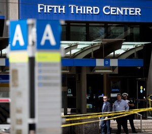 In this Sept. 6, 2018 file photo, police investigate outside Fifth Third Bank building on Fountain Square after a shooting with multiple fatalities in downtown Cincinnati. (Albert Cesare/The Cincinnati Enquirer via AP, File)