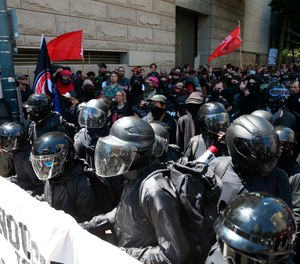 Multiple groups, including Rose City Antifa, the Proud Boys and conservative activist Haley Adams protest in downtown Portland, Ore., Saturday, June 29, 2019. (Dave Killen/The Oregonian via AP)
