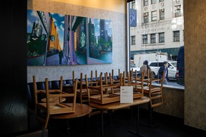 Chairs are stacked in a Starbucks coffee shop that remained open for customers purchasing for take-away, Monday, March 16, 2020, in New York. Image: AP Photo/John Minchillo