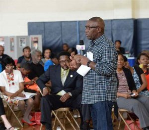 CMPD Police Chief Rodney Monroe is pictured speaking to attendees at a 'Cops and Barbers' event. (Photo courtesy CMPD)