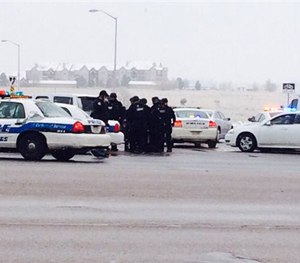 Authorities respond after reports of a shooting near a Planned Parenthood clinic Friday, Nov. 27, 2015, in Colorado Springs, Colo. (Kody Fisher/FOX21 News via AP)