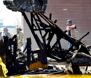 Investigators stand by as debris is removed from a house that was destroyed in a deadly explosion in Firestone, Colo. (Matthew Jonas/The Daily Times Call via AP)