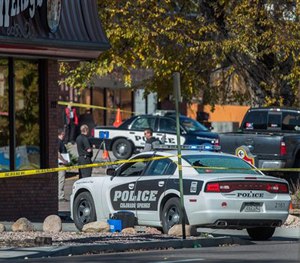 The rear window of a Colorado Springs Police car is shattered after a shooting Saturday, Oct. 31, 2015, in Colorado Springs, Colo. (Christian Murdock/The Gazette via AP)