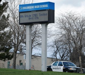 A patrol car is parked in front of Columbine High School in Littleton, Colo., where two student killed 12 classmates and a teacher in 1999.