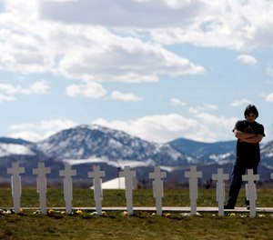 Garrett Bentley looks at a display of crosses for the 13 victims of the massacre at Columbine High School to mark the 10th anniversary of the killings near the Columbine Memorial in the southwest Denver suburb of Littleton, Colo., on Monday, April 20, 2009.