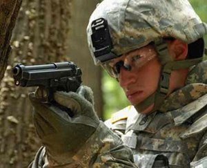 A United States Army soldier in 2009 demonstrates the usage of his Beretta M9 sidearm