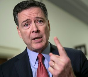 In this Dec. 17, 2018, file photo, former FBI Director James Comey speaks to reporters on Capitol Hill Washington. (AP Photo/J. Scott Applewhite, File)