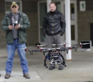 In this Feb. 13, 2014, photo, members of the Box Elder County Sheriff's Office search and rescue team fly their search and rescue drone during a demonstration, in Brigham City, Utah.