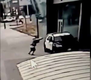 A still frame from a security camera shows the alleged gunman firing into a Los Angeles County patrol car.