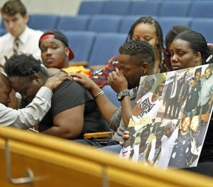 Matrice Stanley, at left in black, sister of Donnell Thompson, 27, who was fatally shot by Los Angeles County Sheriff's deputies in Compton, Calif., and other family members appear before Los Angeles County supervisors at the County Hall of Administration in downtown Los Angeles Tuesday, Aug. 9, 2016. (AP Photo/Nick Ut)