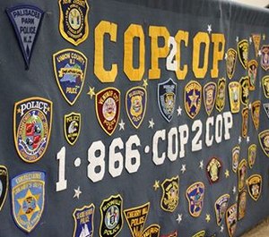 A banner displays Cop2Cop's helpline number. (Photo/Cop2Cop via Facebook)