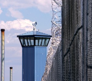 In this Aug. 31, 2007, file photo, a guard tower is seen behind the wire fence that surrounds California State Prison, Sacramento, in Folsom, Calif.